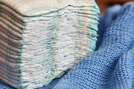 Stack of diapers or nappies on knitted blanket, closeupの写真素材