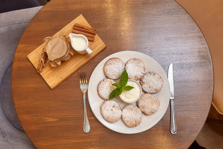 Cottage cheese curd pancakes or fritters with mint. Traditional Russian and Ukrainian cuisineの写真素材