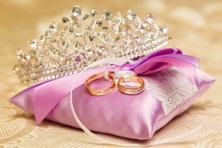 Golden wedding rings on the purple lace pillow, closeup. Marriage conceptの写真素材