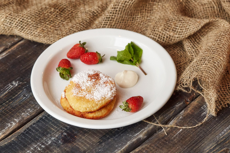 Breakfast with pancakes, strawberry on wooden background, top viewの写真素材