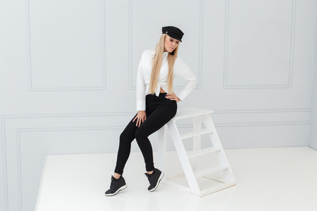 Fashion portrait of women in black and white suit on light backgroundの写真素材