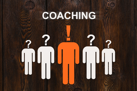 Coaching concept. Paper men on wooden background. Abstract business conceptual imageの写真素材