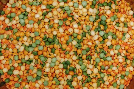 Pea and lentil. Green and orange food background, top view