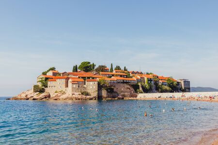 SVETI STEFAN, MONTENEGRO - SEPTEMBER 16, 2019: Sveti Stefan island and beach with tourists on sunny summer dayのeditorial素材
