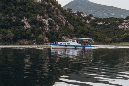 RIJEKA CRNOJEVICA, MONTENEGRO - SEPTEMBER 11, 2019: Touristic passenger boat on excursion to Lake Skadar National Park in Montenegroのeditorial素材