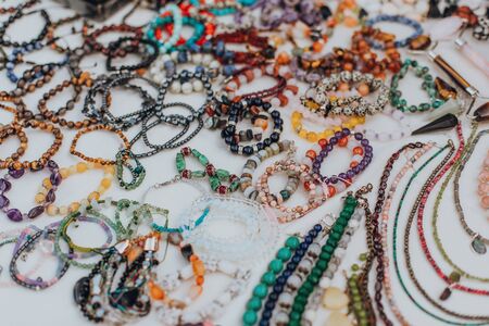 Set of natural material jewellery bracelets and necklaces on the market displayの写真素材