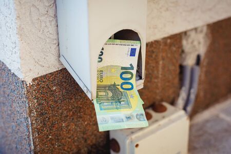 Hundredth euro banknotes in drainpipe. Money or business concept. Abstract conceptual imageの写真素材