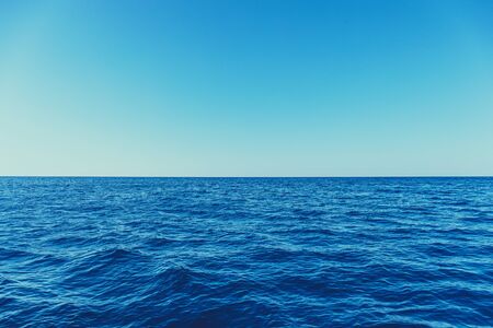 Blue sea surface background with waves and horizonの写真素材