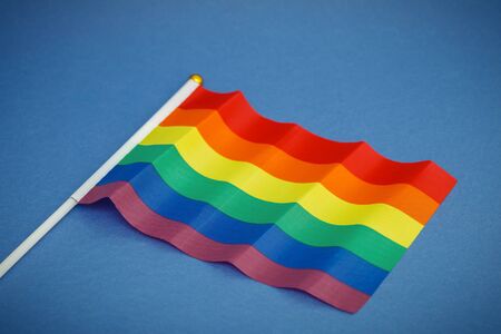 Six colored flag of the LGBT community on blue background