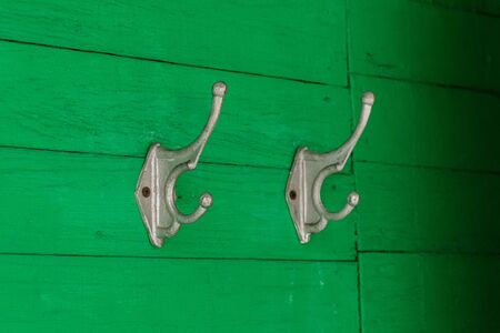 Hooks or hangers on wall of green wooden houseの写真素材