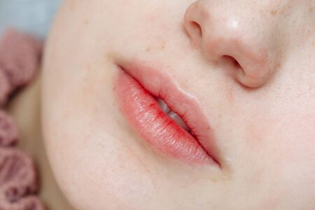 Lips after permanent makeup in beauty salon, macro viewの写真素材