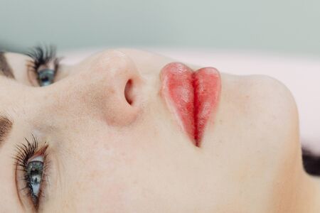 Lips after permanent makeup in beauty salon, macro viewの写真素材