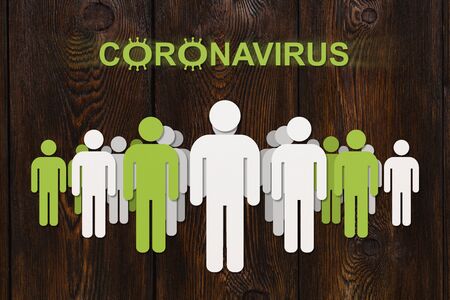 Coronavirus spread concept. Paper white and green men on wooden backgroundの写真素材