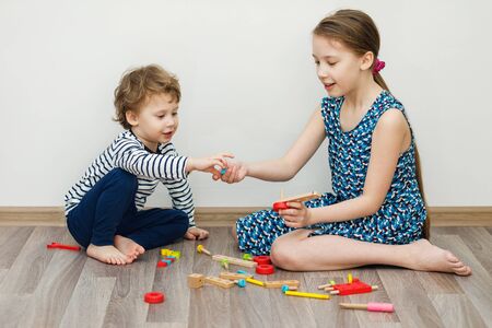 Boy and girl sitting and playing. Stay home concept, quarantine from Coronavirus Covid-19の写真素材