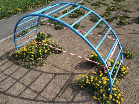 Empy children playground closed for Coronavirus or Covid19. Wrapped in police tape because of...
