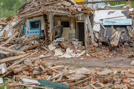 Rubble of old ruined house. Pile of construction fragments in ruins