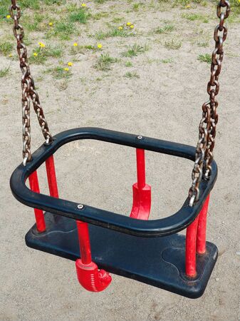 Children playground and plastic empty swing vertical backgroundの写真素材