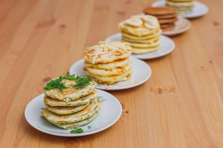Stack of various pancakes on wooden table, food backgroundの写真素材