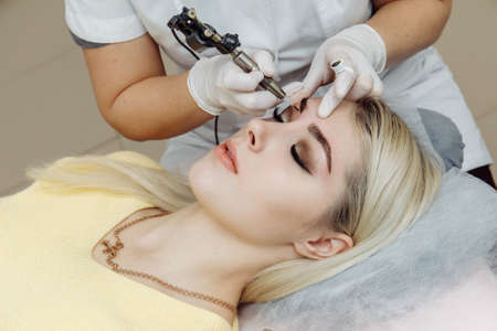 Result of permanent makeup, tattooing of eyebrows in beauty salonの写真素材