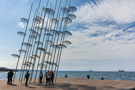 THESSALONIKI, GREECE - SEPTEMBER 30, 2017: People walking under Umbrellas sculpture in of of city of Thessaloniki, Central Macedonia, Greeceのeditorial素材