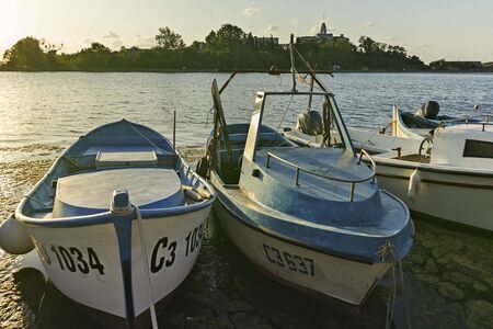 SOZOPOL, BULGARIA - AUGUST 9, 2018: Sunset view with Boat at port of Sozopol, Burgas Region, Bulgariaのeditorial素材