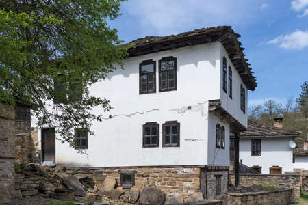 BOZHENTSI, BULGARIA - MAY 3, 2021: Typical street and old houses at historical village of Bozhentsi, Gabrovo region, Bulgariaのeditorial素材