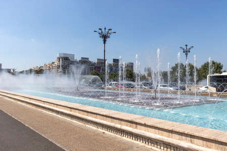 BUCHAREST, ROMANIA - AUGUST 17, 2021: Fountain at Unirii Square at the center of city of Bucharest, Romaniaのeditorial素材