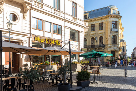 BUCHAREST, ROMANIA - AUGUST 16, 2021: Typical street and buiding at downtown (old town) of city of...