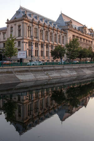 BUCHAREST, ROMANIA - AUGUST 16, 2021: Palace of Justice and Dambovita River passing through the center of city of Bucharest, Romaniaのeditorial素材