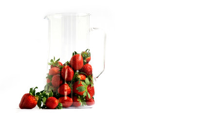 Strawberry. Berry in a glass dish with sun glare. Elegant composition on a white background with space for text.の写真素材