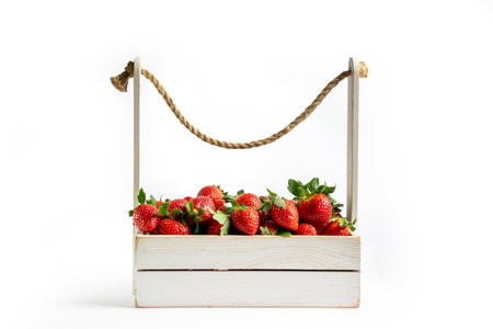 Fresh strawberries in a stylish box on a white background. Impressive background for banner, invitation, advertisement, card.の写真素材