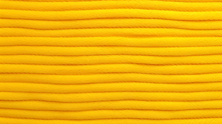 Yellow nylon texture as background, top view. Woolen fabric as an abstract background.の素材