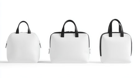 Three versatile white bags with black handles displayed together, showing a modern and minimalist design perfect for work or casual outings.の写真素材