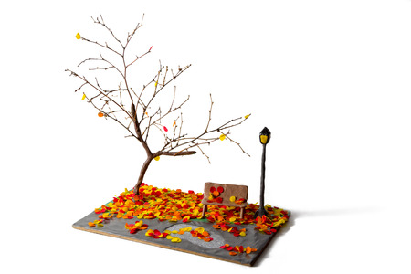 miniature lantern and bench in autumn park made from plasticine sticks and paperの写真素材