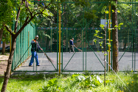 MOSCOW - JUNE 1, 2015: wipers sweep the fenced sports fieldのeditorial素材
