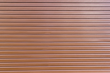 background of glossy brown vinyl siding planks