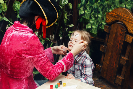 woman paints the face of a girlの写真素材