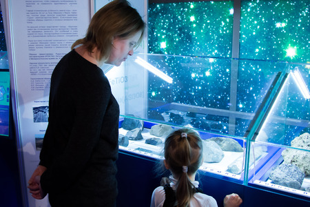 MOSCOW,RUSSIA - November 4, 2016: mother and daughter looking at the exhibits of the Moscow Planetariumのeditorial素材