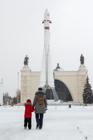 MOSCOW,RUSSIA - November 15, 2016: mother and daughter walk to Vostok space rocket at VVCのeditorial素材