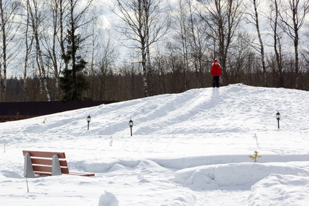 little girl rolling down from snow hill