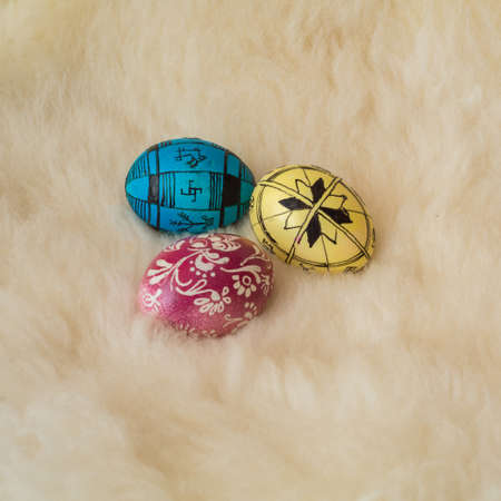 Easter eggs painted in the traditional way lying on sheepÃ¢ï¿½ï¿½s fur.の写真素材