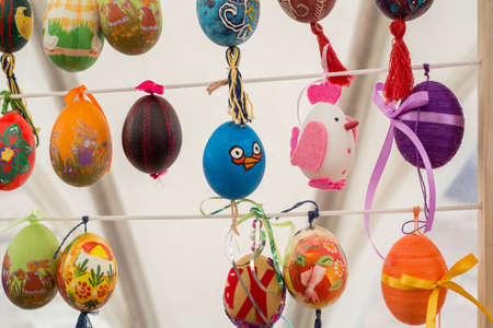 Painted colorful easter eggs on the stringの写真素材