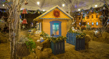 Christmas wooden house and decorations around itの写真素材
