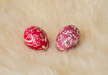 Easter eggs painted in the traditional way lying on sheeps fur.の写真素材