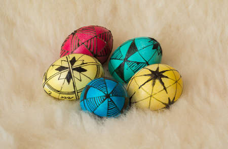 Easter eggs painted in the traditional way lying on sheepÃ¢ï¿½ï¿½s fur.の写真素材