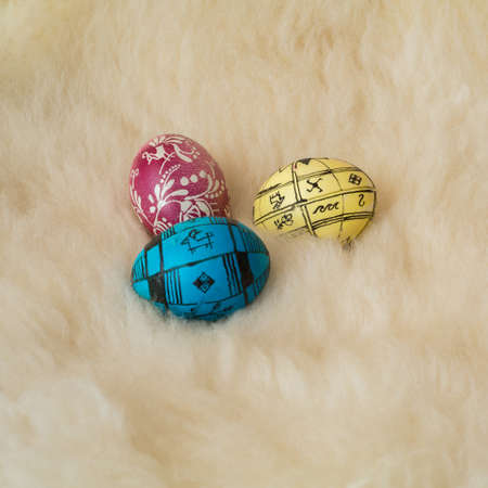 Easter eggs painted in the traditional way lying on sheepÃ¢ï¿½ï¿½s fur.の写真素材