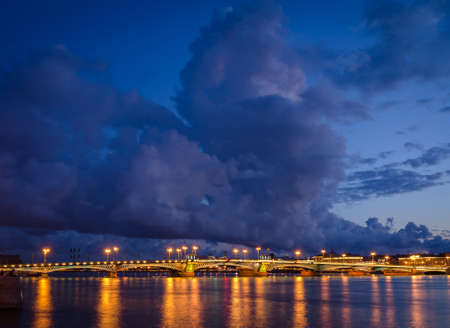 Night cityscape with river and bridge in Saint-Petersburg. Lantern lights on the bridge.の写真素材