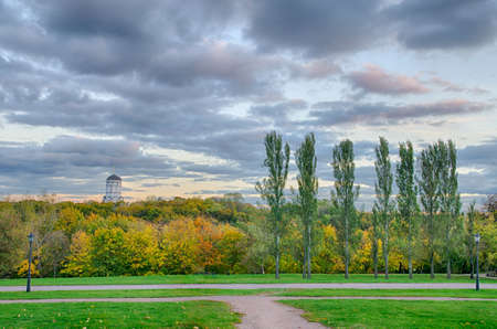 Colorful autumn park with church and cloudsの写真素材