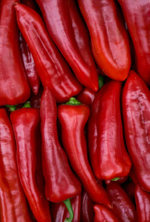 Red paprika peppers closeup lyinf one on another.の写真素材