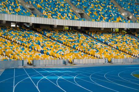 Empty colorful stadium seats and running tracksのeditorial素材